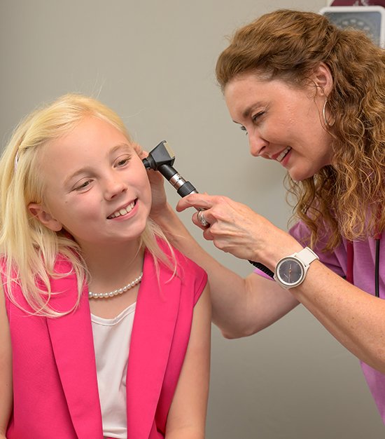 Dr. Lydia Dennis examining young female patient Dr. Lydia Dennis examining young female patient