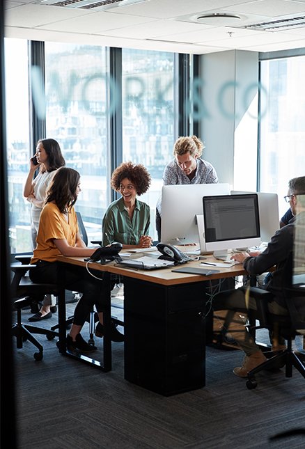 Employees sitting around desk working